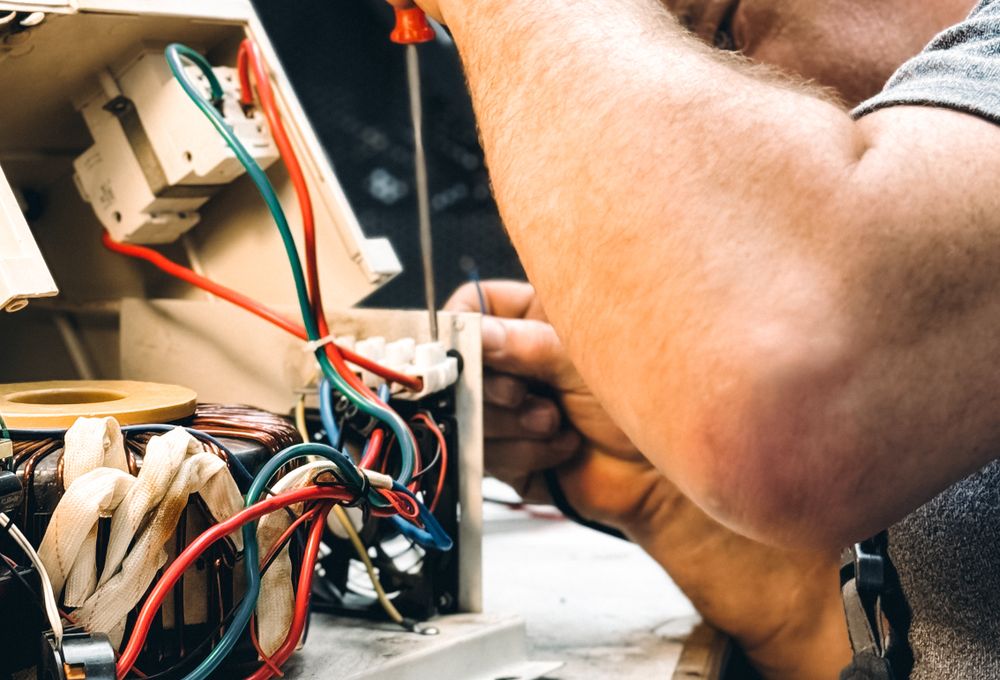 Electrician repairing equipment
